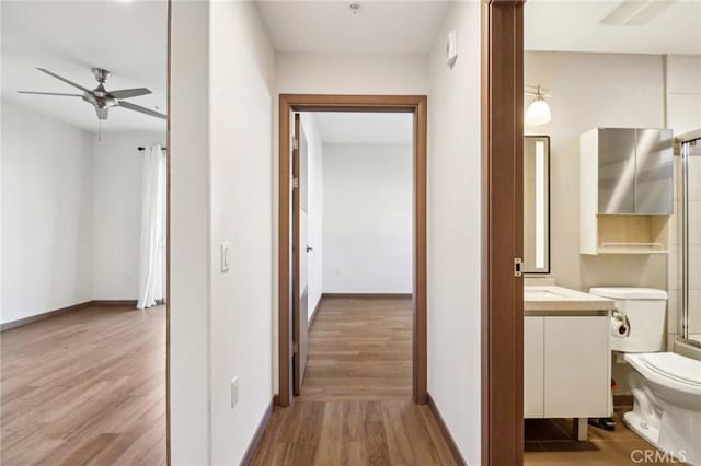 hallway with light hardwood / wood-style floors