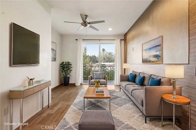 living room with ceiling fan and light wood-type flooring