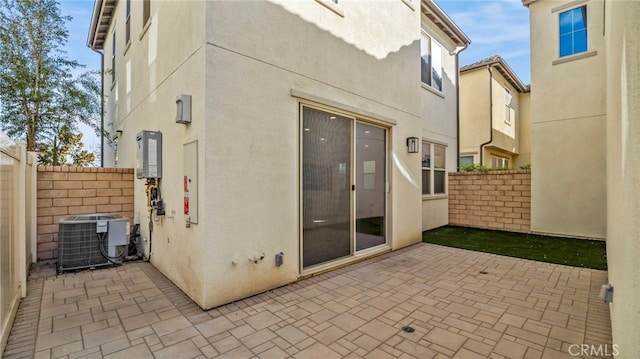 rear view of house featuring a patio area and central AC unit