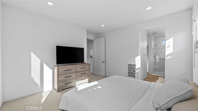 carpeted bedroom featuring ensuite bath