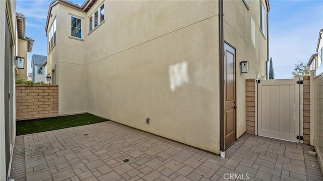 view of side of home with a patio area