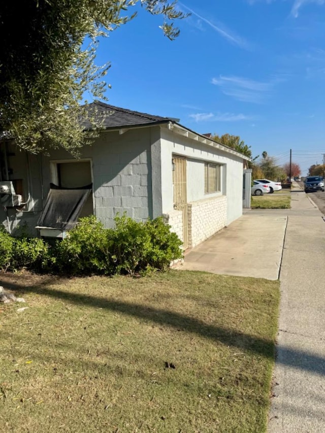 view of home's exterior with a lawn