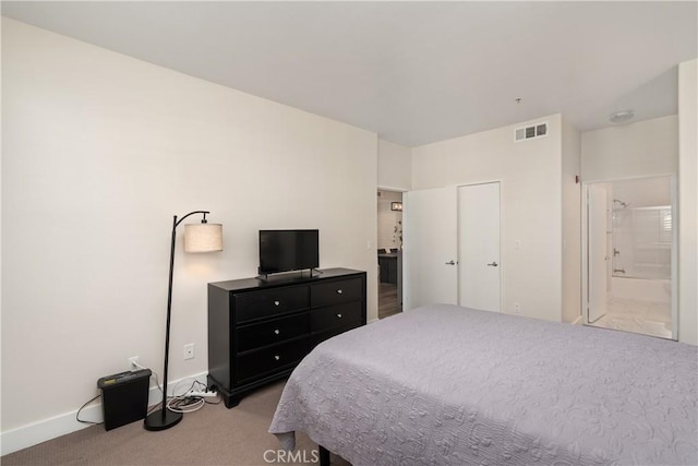 carpeted bedroom featuring ensuite bathroom