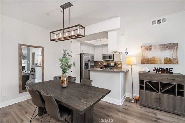 dining space featuring hardwood / wood-style floors