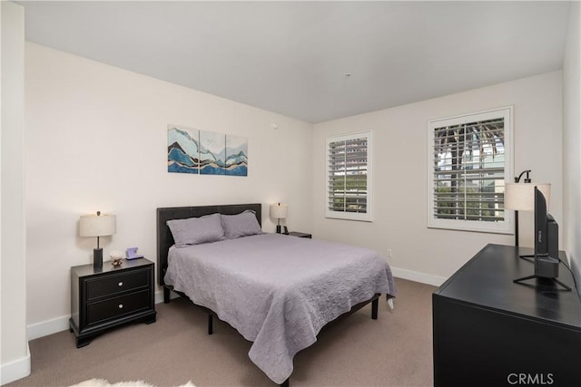 bedroom featuring light carpet