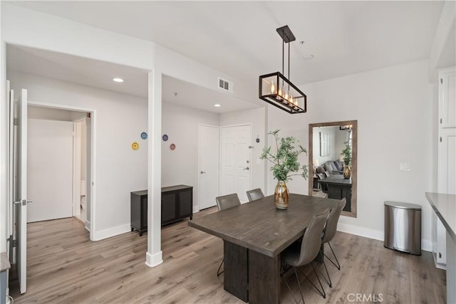 dining space with light hardwood / wood-style flooring