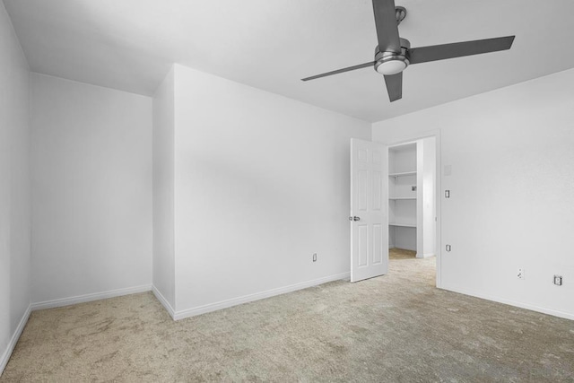 unfurnished room featuring light colored carpet and ceiling fan