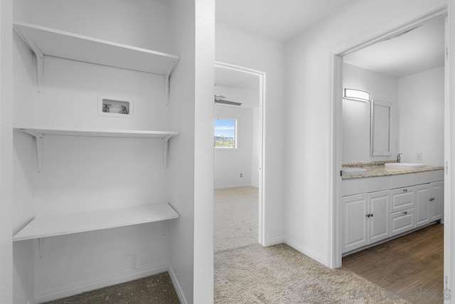 bathroom with hardwood / wood-style floors, vanity, and ceiling fan