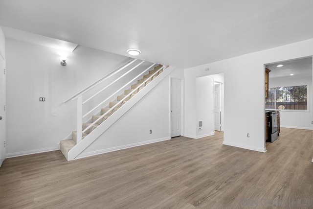 unfurnished living room with hardwood / wood-style flooring