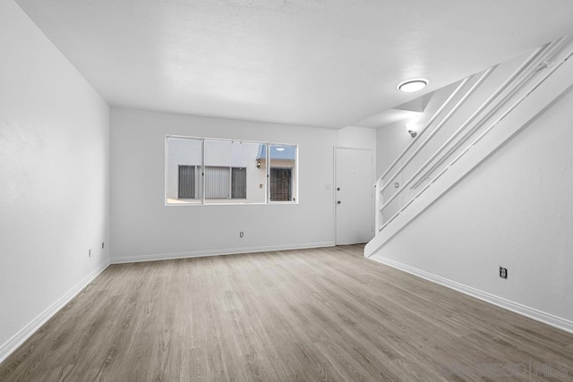 unfurnished living room with wood-type flooring