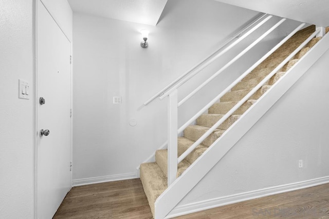 stairs featuring hardwood / wood-style flooring