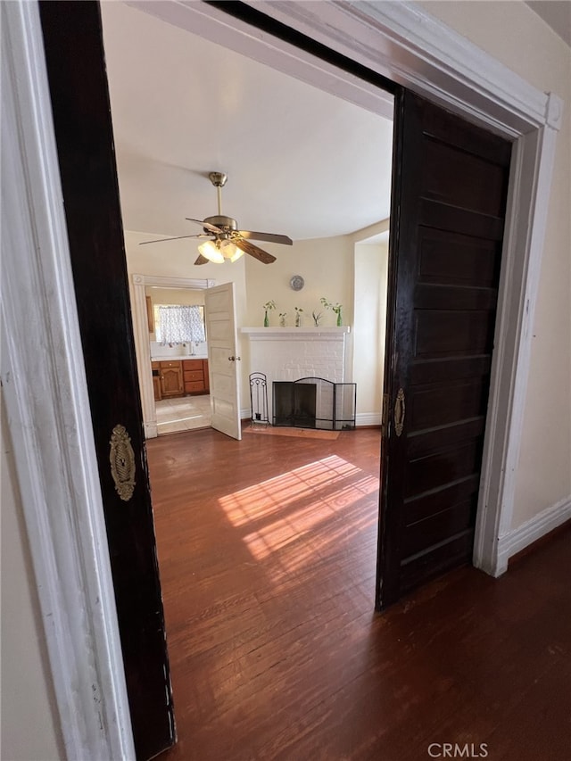 unfurnished living room with ceiling fan and hardwood / wood-style floors