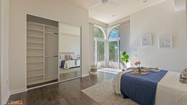 bedroom featuring access to exterior, dark hardwood / wood-style flooring, a closet, and ceiling fan