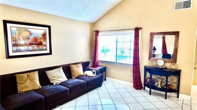 living room featuring a textured ceiling, light tile patterned flooring, and lofted ceiling