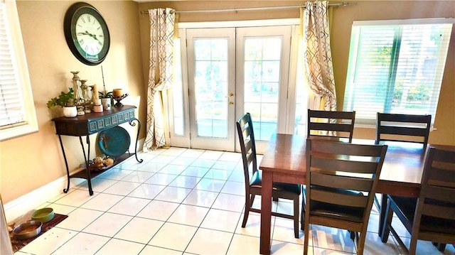 dining space with french doors and light tile patterned floors