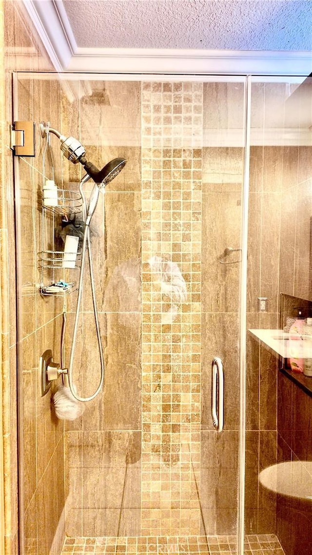 bathroom with a textured ceiling and an enclosed shower