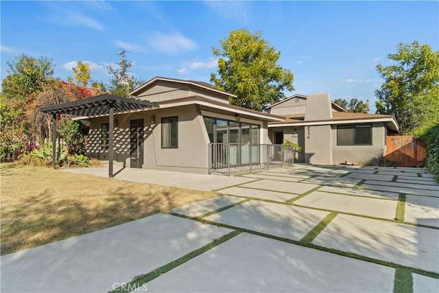 back of house featuring a pergola and a patio area