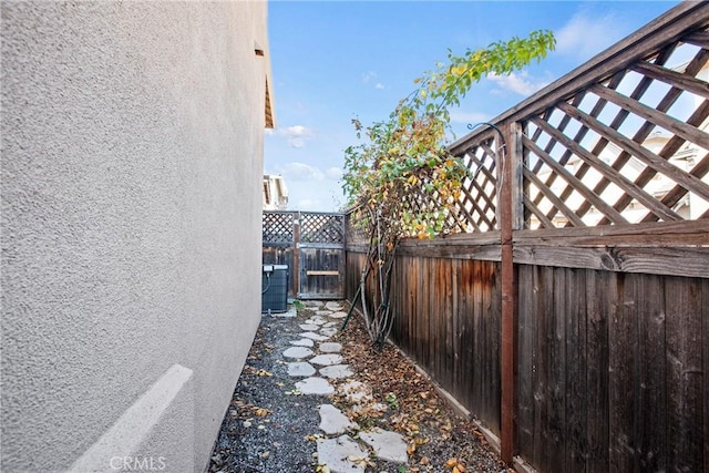 view of side of home with central AC unit