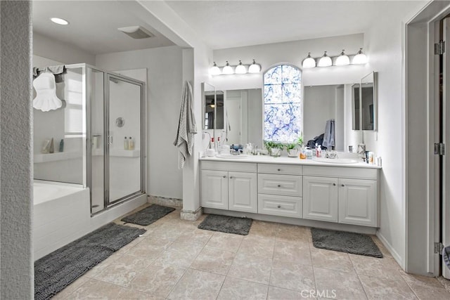 bathroom with vanity and separate shower and tub