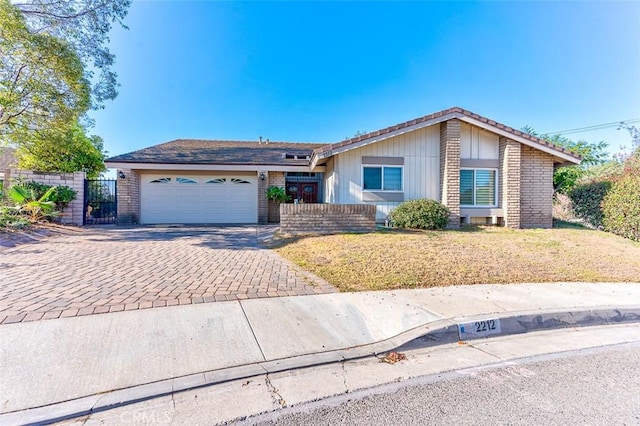 ranch-style house featuring a front yard and a garage