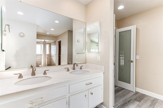 bathroom featuring wood-type flooring and vanity