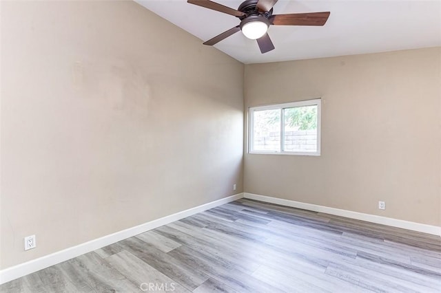 unfurnished room featuring ceiling fan, light hardwood / wood-style floors, and vaulted ceiling