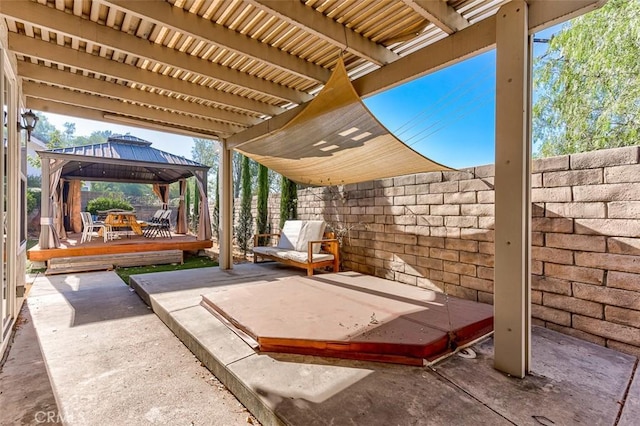 view of patio / terrace with a gazebo, a jacuzzi, and a deck