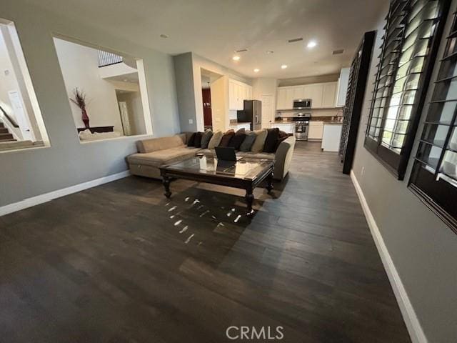 living room with dark hardwood / wood-style flooring