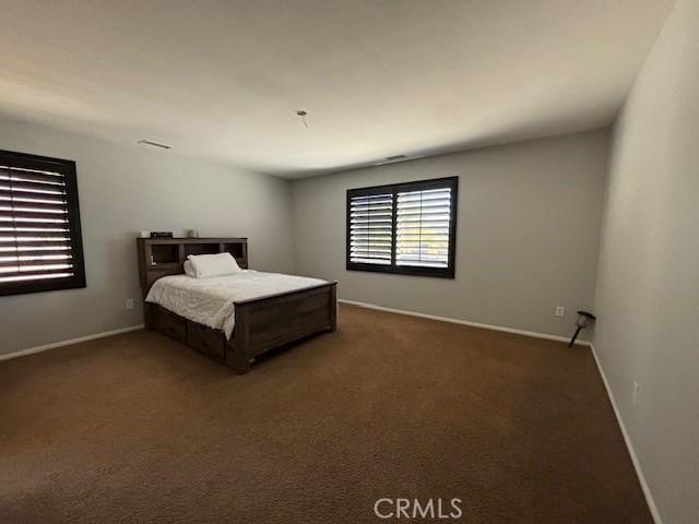 unfurnished bedroom featuring dark carpet