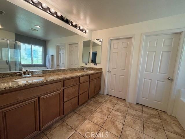 bathroom with tile patterned floors, vanity, and independent shower and bath