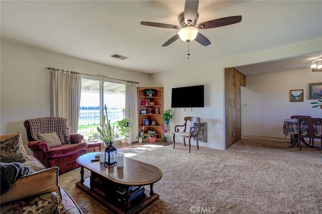 carpeted living room featuring ceiling fan