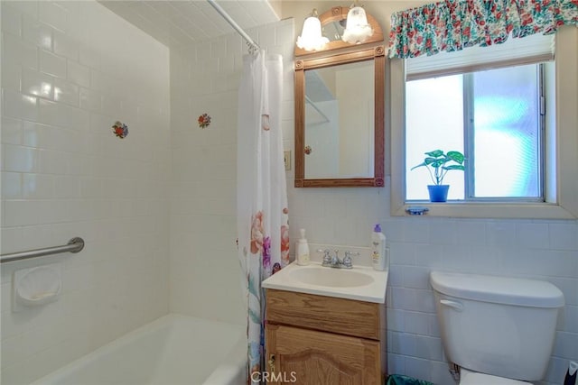 full bathroom with shower / tub combo, vanity, toilet, and tile walls