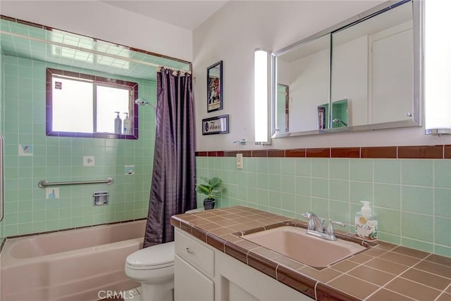 full bathroom with vanity, shower / tub combo, and toilet