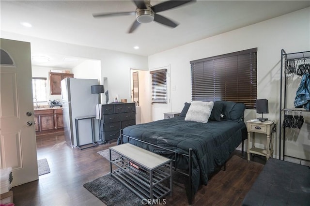 bedroom with ceiling fan, dark wood-type flooring, and fridge