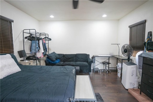 bedroom with ceiling fan and dark hardwood / wood-style floors