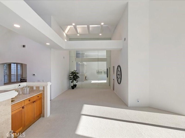 hall featuring recessed lighting, light colored carpet, and visible vents