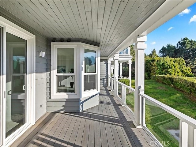 wooden deck with a lawn