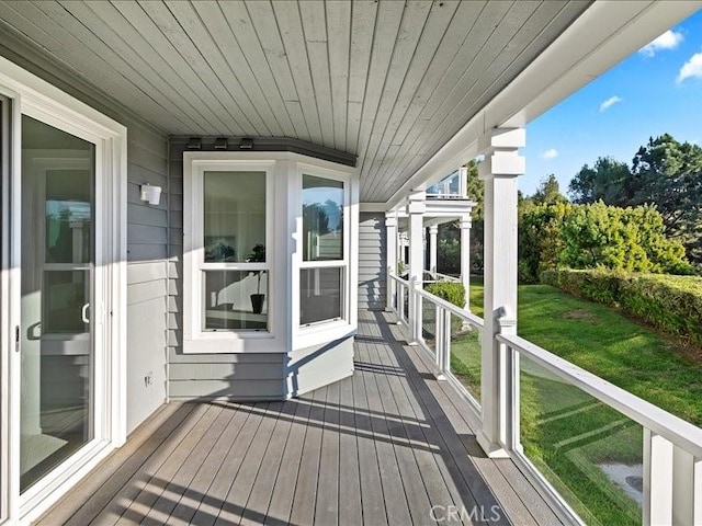 wooden terrace with a yard