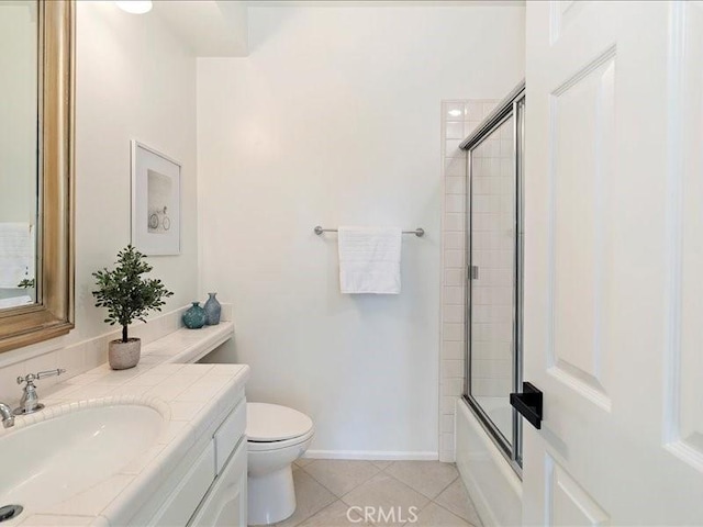 full bathroom with shower / bath combination with glass door, tile patterned flooring, vanity, and toilet