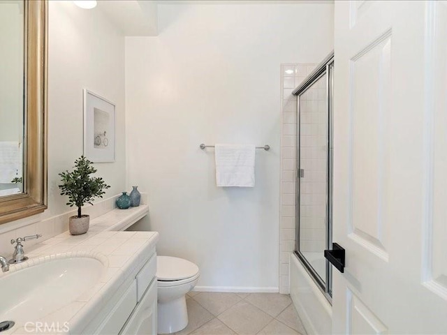 bathroom with toilet, tile patterned floors, shower / bath combination with glass door, and vanity