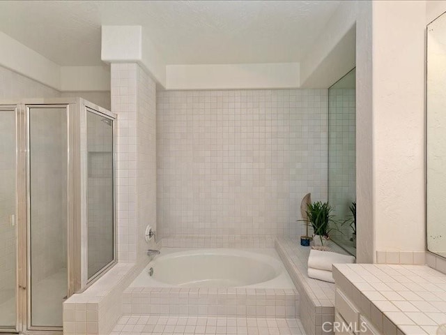 bathroom featuring vanity and independent shower and bath