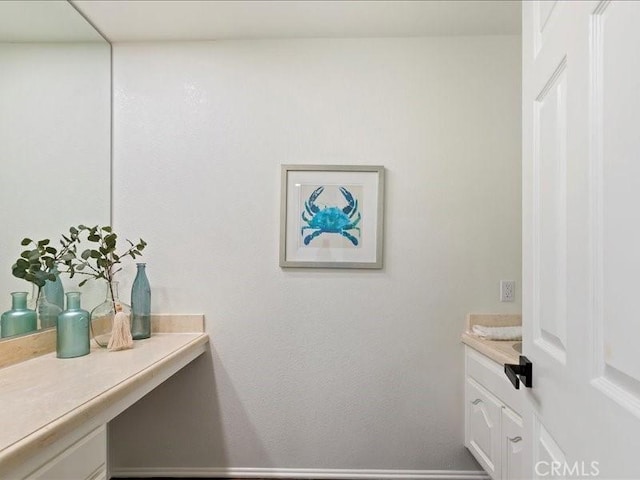 bathroom featuring baseboards and vanity