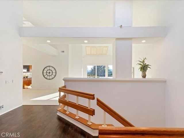 staircase featuring recessed lighting, baseboards, visible vents, and wood finished floors