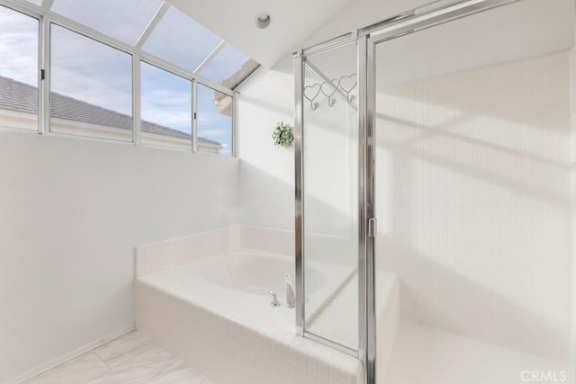 bathroom featuring shower with separate bathtub