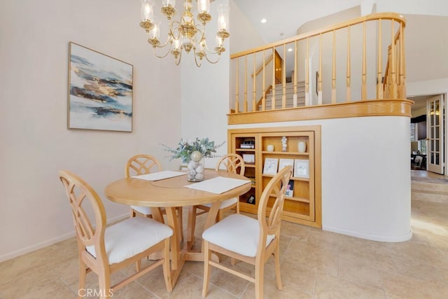 dining space featuring built in shelves, a notable chandelier, and a high ceiling