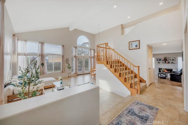 living room featuring high vaulted ceiling, beamed ceiling, and a healthy amount of sunlight