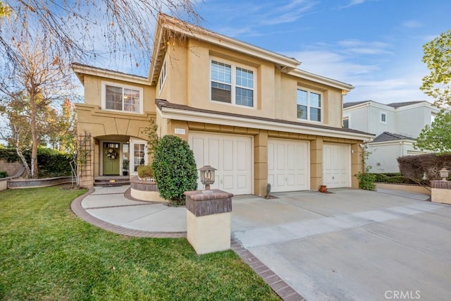 view of front of house with a garage and a front yard