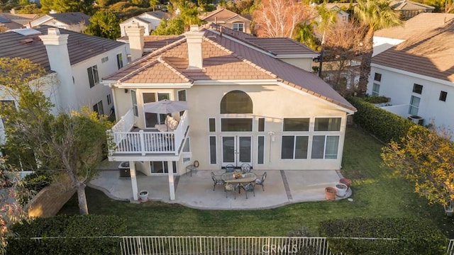 back of property featuring a lawn, central AC unit, french doors, and a patio