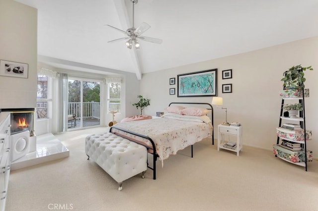 carpeted bedroom featuring ceiling fan, a fireplace, vaulted ceiling with beams, and access to outside