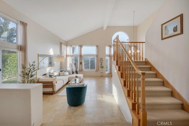 living room featuring beam ceiling and high vaulted ceiling